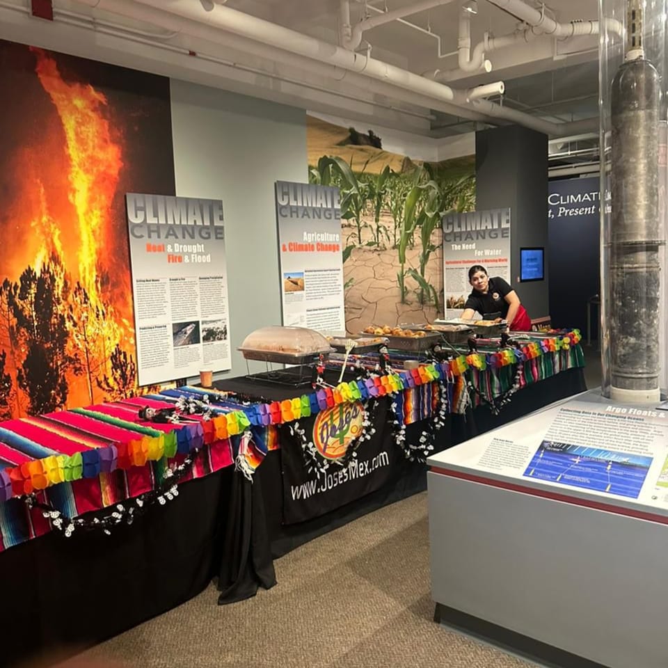 A José's Torta Mexicana food stall with a server, colorful decorations, and food warmers.